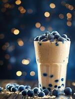 Boba milk tea topped with fresh blueberries on a wooden table photo