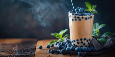 Boba milk tea topped with fresh blueberries in a cozy setting photo