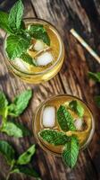 Refreshing green mint lemonade with ice served in clear glasses photo