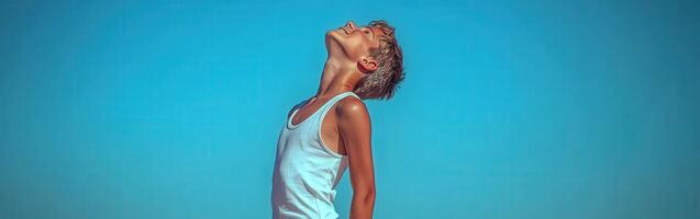 High school boy gazing at the clear sky on a sunny day photo