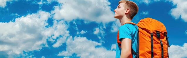 High school boy looking up at a blue sky on a sunny day photo