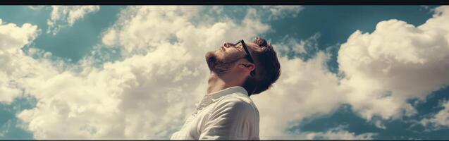 High school boy gazing thoughtfully at the sky on a sunny day photo