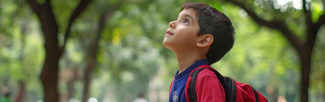 High school boy gazing at the cloudy sky in a park during afternoon photo
