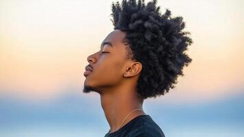 High school boy gazing thoughtfully at the evening sky photo