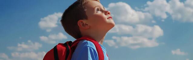 High school boy gazing at the cloudy sky during afternoon outdoors photo