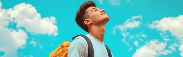 High school boy gazing at the bright blue sky during sunny day photo