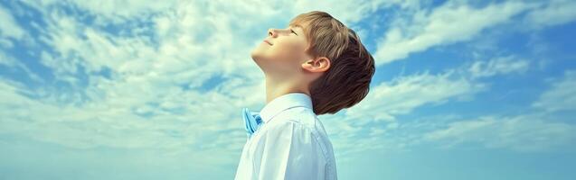 High school boy gazing at the sky during a sunny afternoon photo