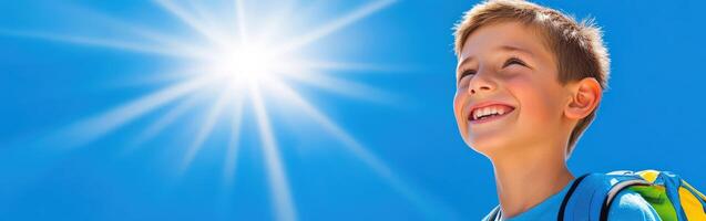 High school boy gazing at a bright sky during a sunny day photo