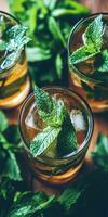 Refreshing green mint lemonade with ice cubes in summer sun photo