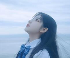 High school girl gazing at the clouds during an overcast afternoon photo