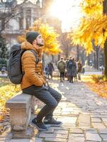 High school boy gazing at the sky during autumn in a city park photo