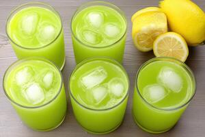 Refreshing green mint lemonade with ice cubes in summer setting photo