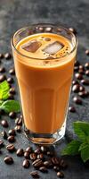 Iced coffee with cream served in a clear glass with coffee beans photo