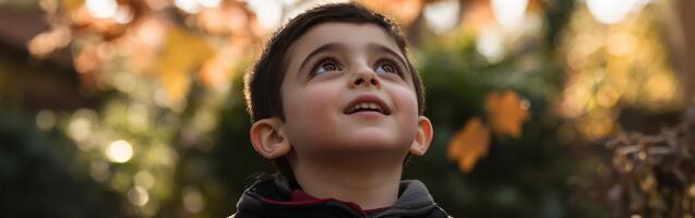 High school boy gazing up at the sky during a sunny afternoon outside photo