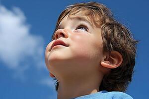 High school boy gazing at the clear blue sky on a sunny afternoon photo