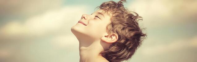 High school boy gazing at the sky on a sunny day photo