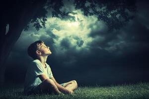 High school boy gazing up at cloudy skies during twilight outdoors photo