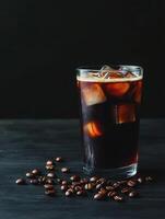 Refreshing iced coffee with cream and coffee beans on a dark table photo