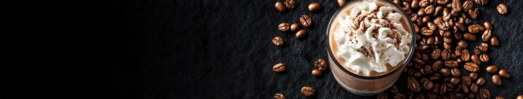 Iced coffee topped with cream and coffee beans on a dark surface photo