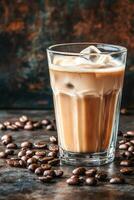 Iced coffee with cream served in a glass surrounded by coffee beans photo