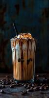 Iced coffee with cream and chocolate drizzle served on a wooden table photo
