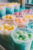 Colorful ice cream pots on display in shop window during sunny day photo