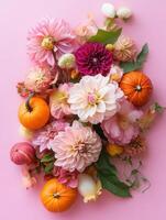 Autumn flowers and pumpkins arranged in warm seasonal colors photo
