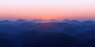 Fog-covered mountains at dusk creating a serene evening atmosphere photo