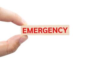 Text EMERGENCY on wooden block. Financial and business concept. retirement saving concept. money saving for rainy day. isolated on white background and clipping path. photo