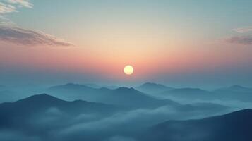 Fog-covered mountains at sunset with a glowing sun photo