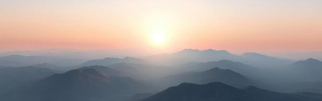 Evening fog blankets mountains as the sun sets behind peaks photo