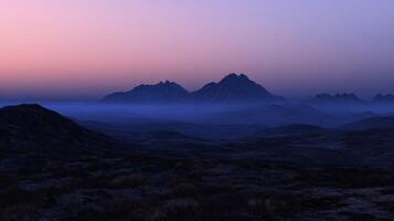 Foggy mountains in the evening light at twilight photo