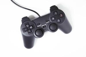 Black controller on white background, game device, Joystick on a white background. photo