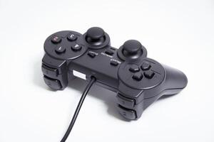 Black controller on white background, game device, Joystick on a white background. photo