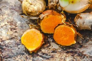 Turmeric or Curcuma longa Linn or rhizome root, a tuber plant that has a distinctive color and aroma photo