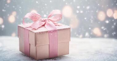 in stunning 4K resolution captures a beautifully wrapped gift box with a pink ribbon, set against a festive backdrop featuring pine branches and twinkling lights video