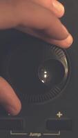 Hand tuning fm radio button. Retro image processed. Hand adjusting volume control. Broadcasting and music concept. woman turning button of radio in car. Woman hand adjusting volume control. video