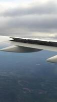 Looking trough window of an aircraft, airplane or plane wing. View from plane window during landing or takeoff over the city urban area video