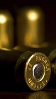 Bullets closeup on black backgrounds. Rubber bullets macro with limited dof on a black background, 9mm full metal jacket. bullet macro with limited dof on a black background video
