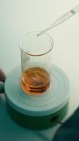 Scientist using a pipette to put solution in glass flask. Stock footage. Concept of medicine and chemistry. video