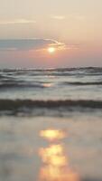 Sun above waving river and shore. Cloudy sky and rippling water, close up. video