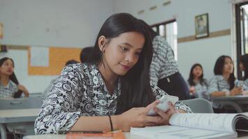 Student using smart phone in classroom video