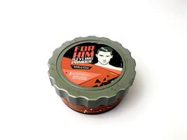 a can of styling pomade on a white surface. Indonesia, Sibolga, 10 August 2024. photo