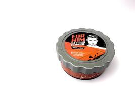 a can of styling pomade on a white surface. Indonesia, Sibolga, 10 August 2024. photo