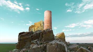 Stone tower with debris on background of sky. Motion. 3D model of historical stone fragments of architecture. Ruins of stone structure for historical games or presentations video