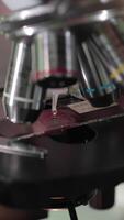 Close up of examining of test sample under the microscope in laboratory. Close up of microscope at the blood laboratory. Microscope at laboratory and hands of the scientist close up video