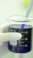 Test tubes closeup. Medical equipment. Close-up footage of a scientist using a micro pipette in a laboratory. Laboratory technician injecting liquid into a microtiter plate. Test tubes. Small depth of video