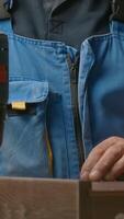 Close up of a man carpenter using screwdriver while working with a wooden product. Creative. Woodwork at the workshop. video