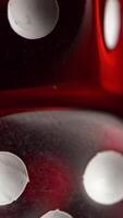 Red dices on black background. Red dice standing on each other, macro on black background video