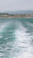 View of the blue calm sea. Action. View from a moving boat that floats creating waves and the resort landscape is visible video